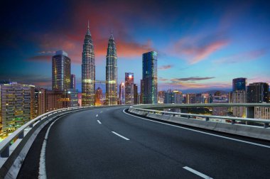 Flyover with beautiful Kuala Lumpur city skyline , Twilight scene . clipart