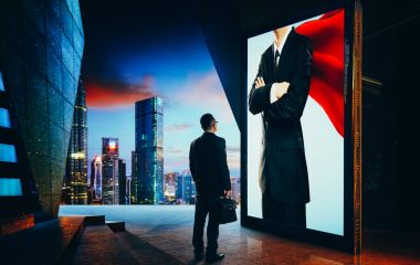 Young businessman looking the hero businessman on the advertising billboard screen . Successful businessman concept . clipart
