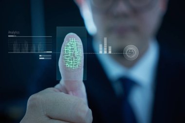 Young businessman scan fingerprint for identity analytics , concept of the internet and future immersive technology for business security .