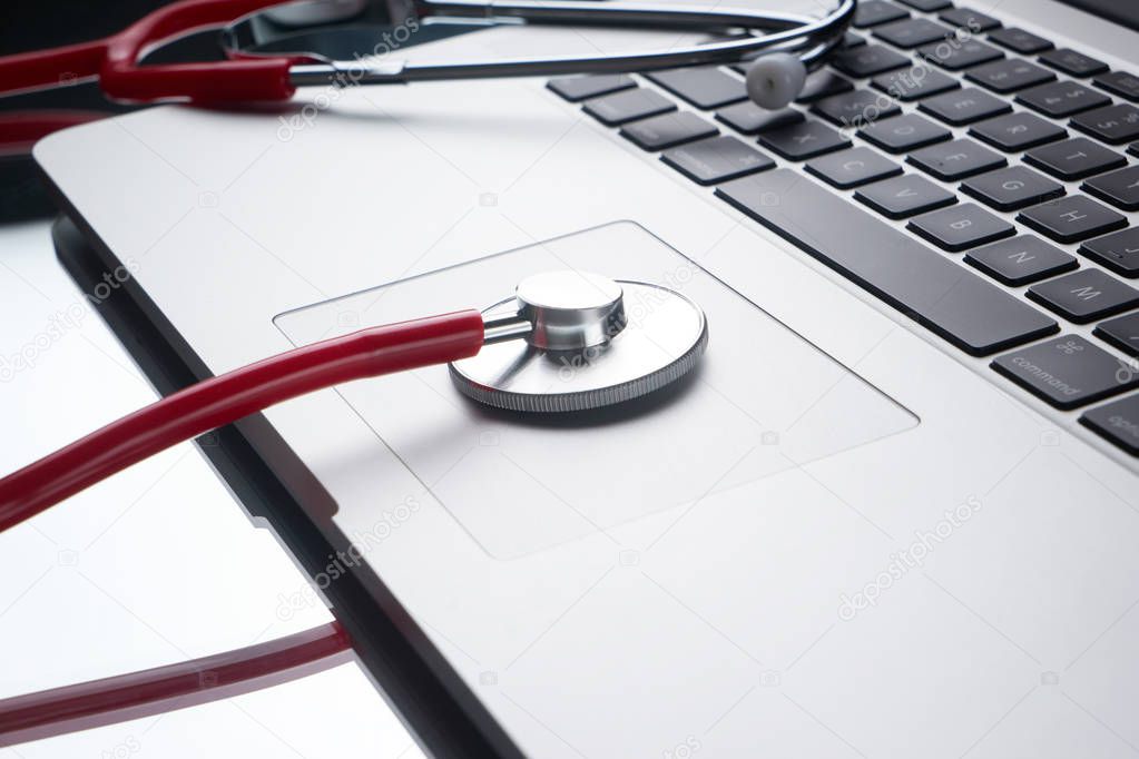Laptop diagnosis with a stethoscope. computer repair and service concept.