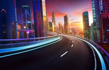 Highway overpass motion blur with city skyline and urban skyscrapers , sunset and twilight scene. clipart