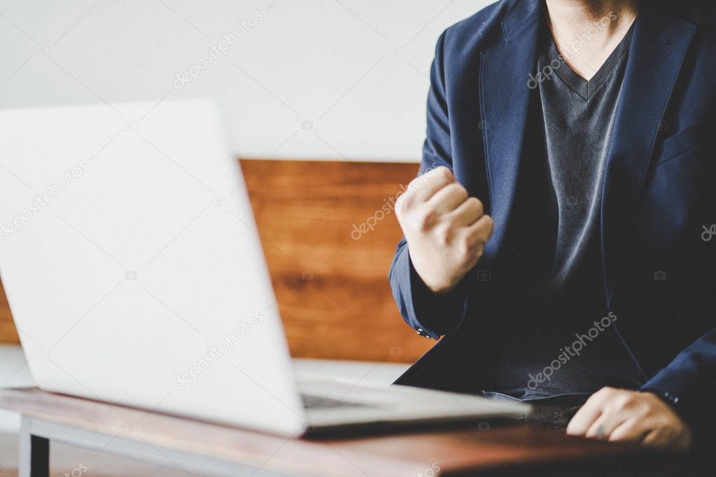  businessman excited clenched fist 
