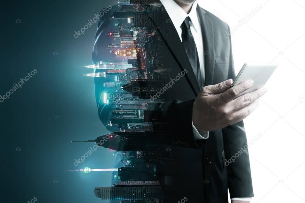 Abstract double exposure image of businessman man using mobile smart phone mix with flip night creative city background . Always stay connected concept .