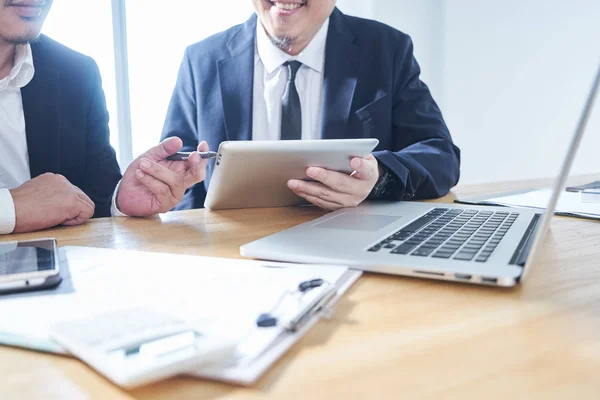 Two businessmen use electronic products in discussing business plan