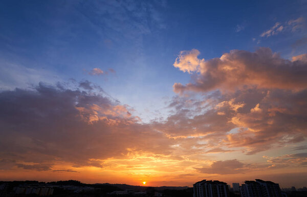 Beautiful sunset with dramatic cloud and blue sky .