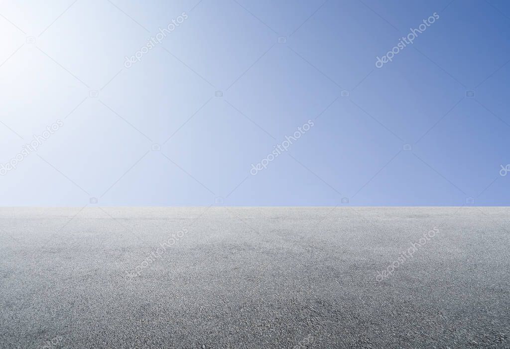 Empty asphalt floor with clear sunny sky background .