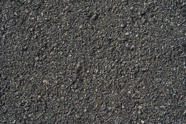 Nahaufnahme schwarze raue Asphaltstraße — Stockfoto