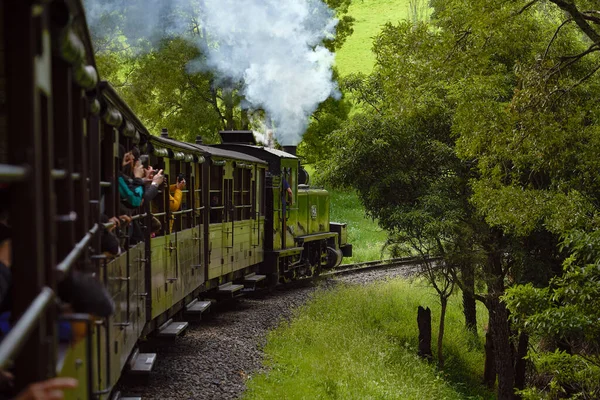 Puffing Billy vintage steam train with passengers in the Dandenong Ranges near Melbourne.