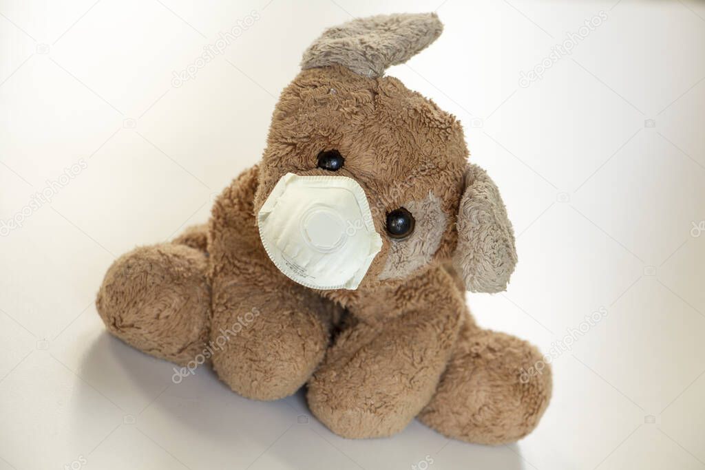 a teddy bear with a ffp2 mask, safe children's toys