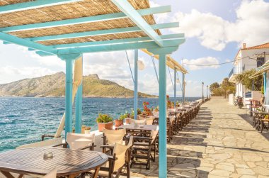 Yaz fotoğraf Aegina Adası Yunanistan üzerinden panoramik manzaralı. Ahşap çatı ile sahil üzerinde öğle yemeği yapmak için güzel bir yer bar ve restoran. Soğutma için güneşli gün boyunca an sihirli ve rahatla