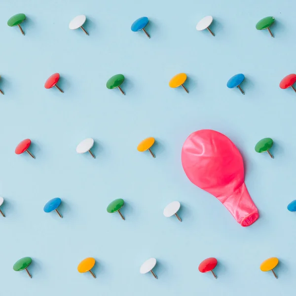 Pink baloon with colorful pins — Stock Photo, Image