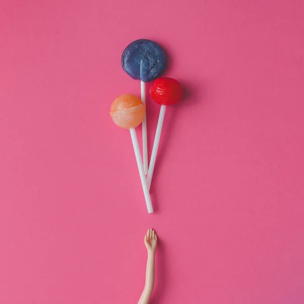 Doll hand with lollipops — Stock Photo, Image