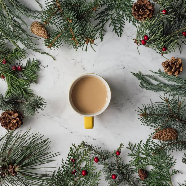 Christmas winter foliage with coffee cup