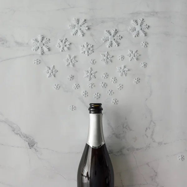 Champagne bottle with white snowflakes