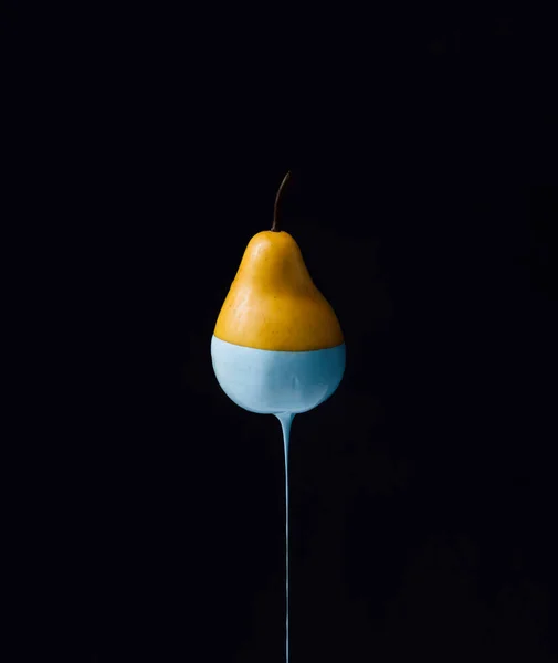 Pear with dripping blue paint — Stock Photo, Image