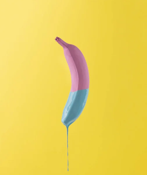 Pink banana with dripping blue paint — Stock Photo, Image