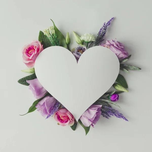 Creative layout with flowers and heart shape — Stock Photo, Image