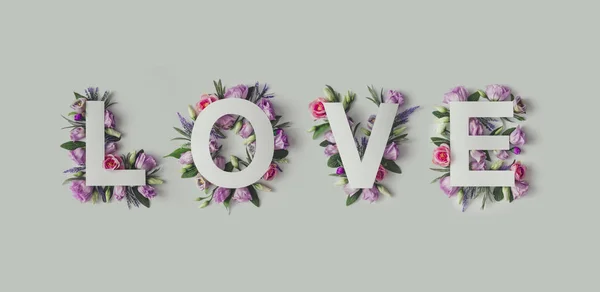 Creative layout with flowers and Word LOVE — Stock Photo, Image