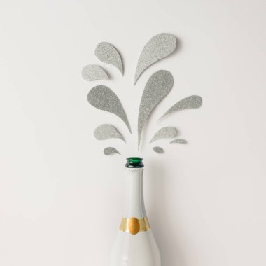 Champagne bottle with silver glittering splashes 