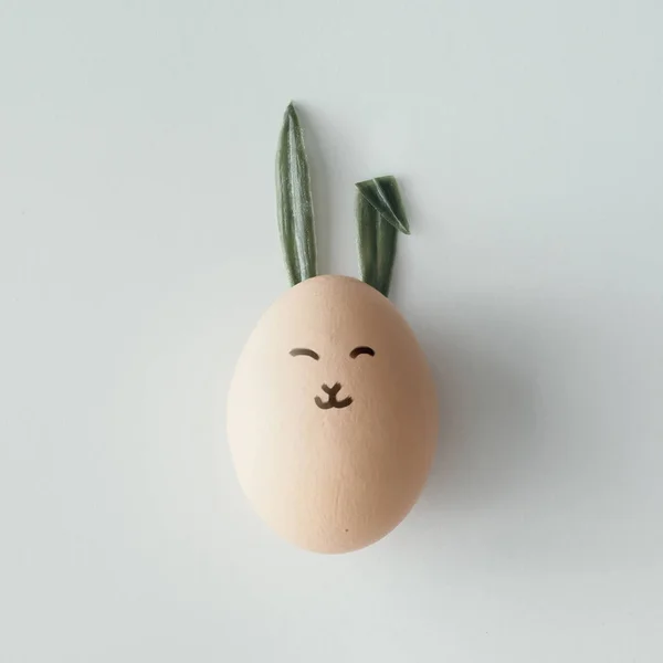 Easter egg with bunny ears and face — Stock Photo, Image