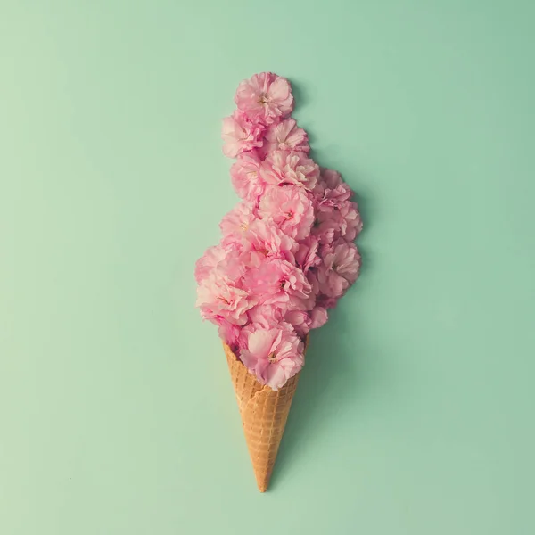 Ice cream cone with pink flowers — Stock Photo, Image