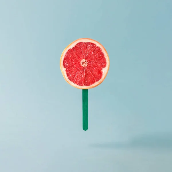 Red grapefruit with ice cream stick — Stock Photo, Image