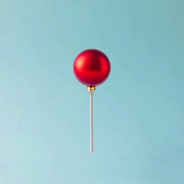 Lollipop made of red Christmas bauble — Stock Photo, Image