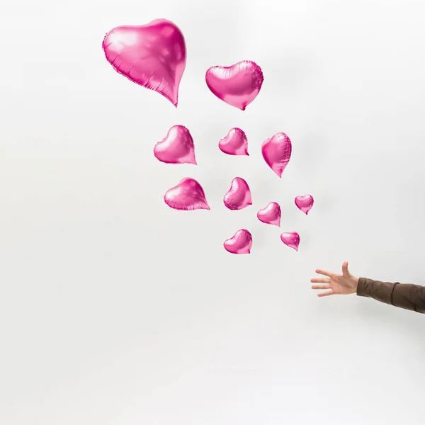 Human Hand Pink Heart Shaped Balloons Floating Light Background Minimal — Stock Photo, Image