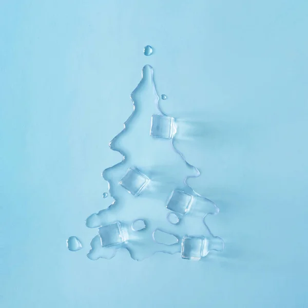 Christmas Tree Shape Made Melting Ice Bright Blue Background Minimal — Stock Photo, Image