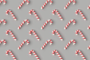 Christmas pattern with candy canes on pastel gray background. Minimal holiday wrap concept.