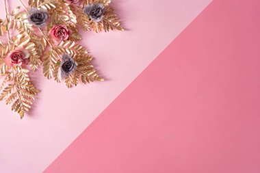 Creative layout made with pastel pink and purple flowers with gold leaves. Nature Trendy Decorative Design. 