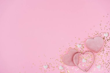 Creative layout with pink hearts and gold glitter on pink background. Minimal love concept
