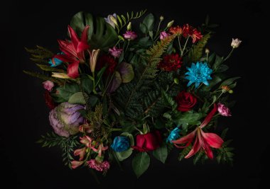 Creative layout made of flowers and leaves. Colorful spring flower background