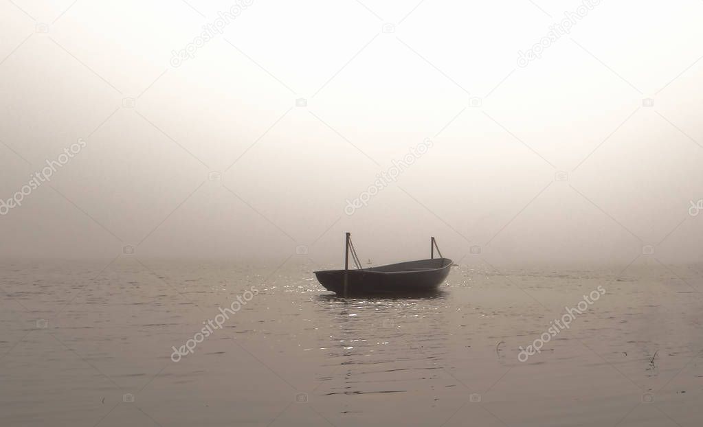 Boat in the foggy sea.