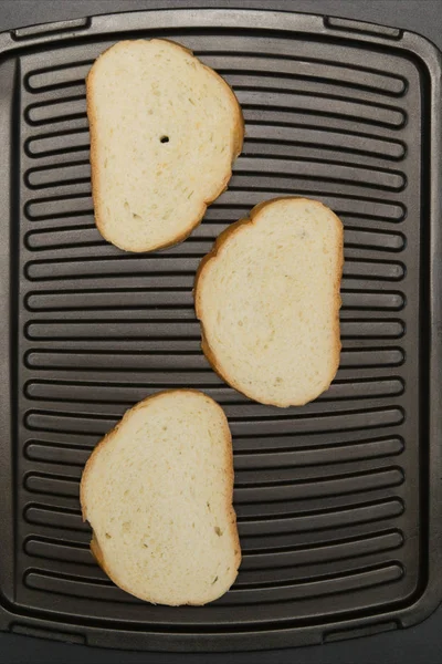 Three slices of white bread is grilled — Stock Photo, Image