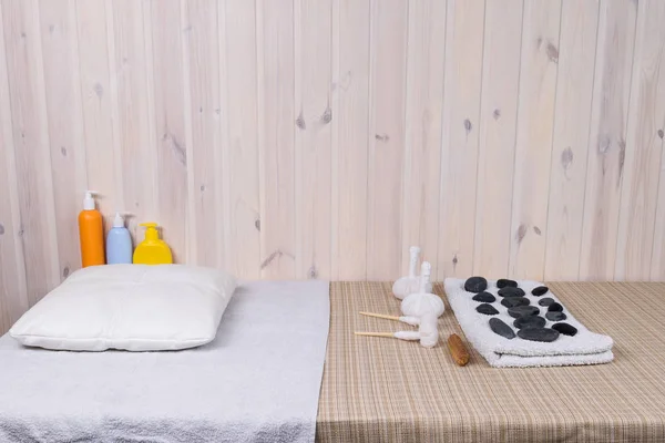 massage table with stones and bags for massage
