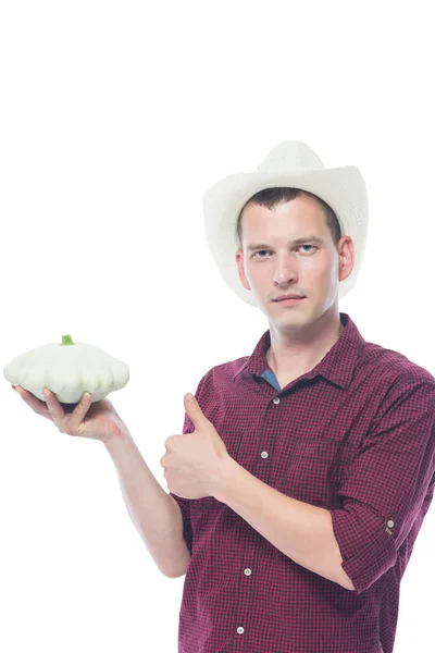 Patisson in den Händen eines Bauern mit Hut — Stockfoto