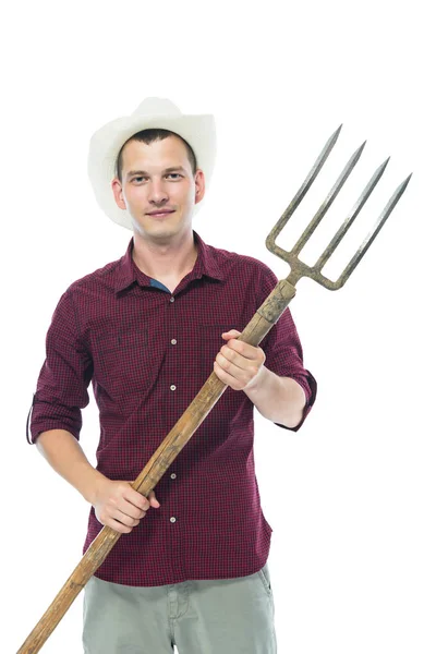 Farmer in the hat holding a pitchfork in his hands — Stock Photo, Image