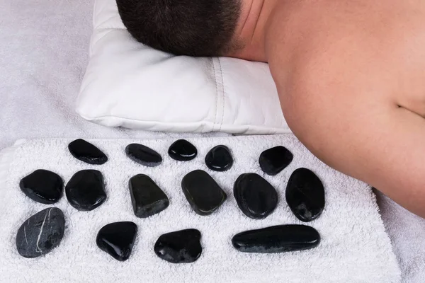 Massage with warm stones man — Stock Photo, Image