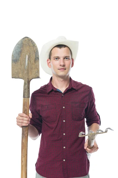 Farmer in the shirt holds the tool for soil processing — Stock Photo, Image