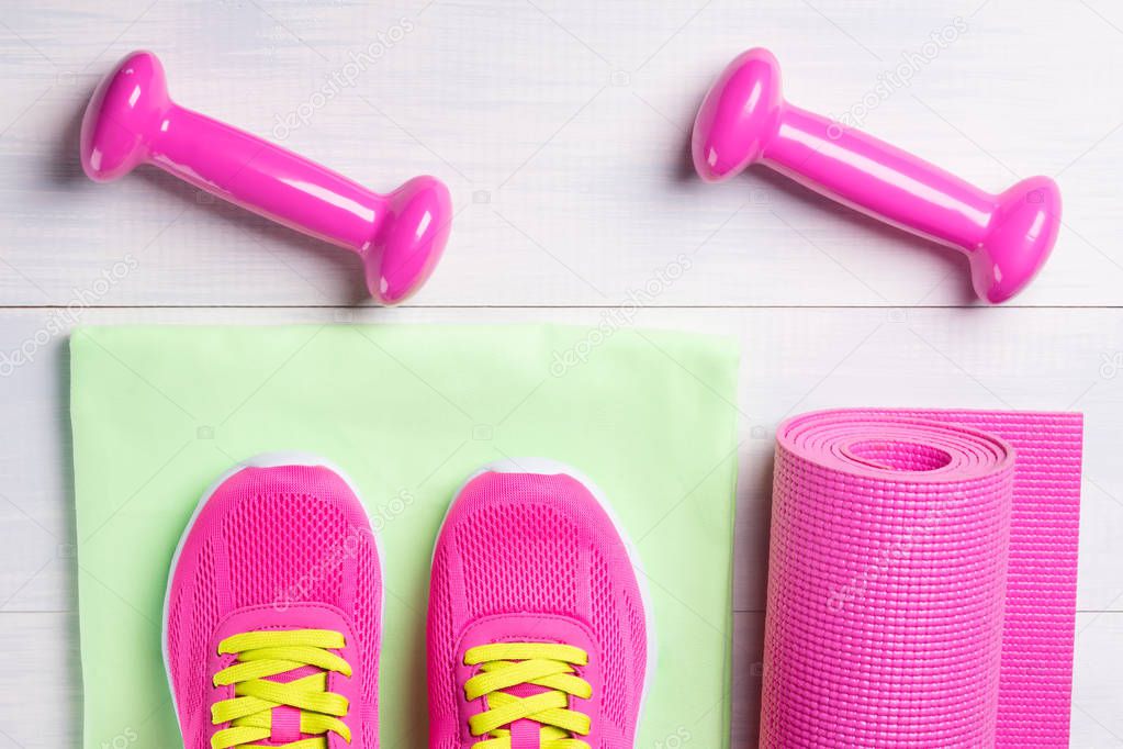 Female set for playing sports, with pink dumbbells