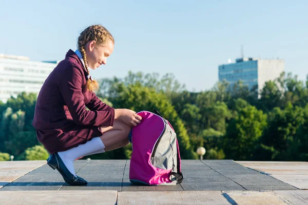 학교 유니폼에서 여자가 열립니다 교과서에 대 한 핑크 가방 — 스톡 사진