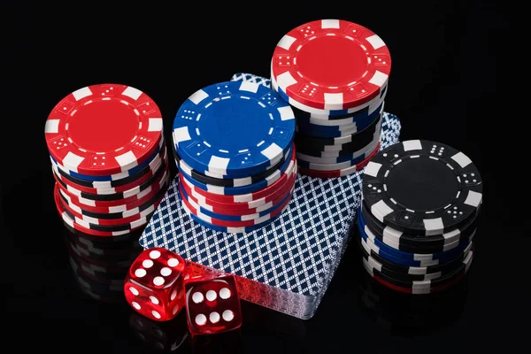 Beautiful dice set, cards and poker chips on a black background — Stock Photo, Image