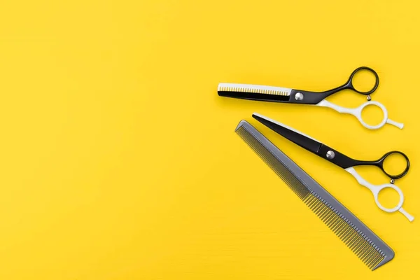 Tools on a yellow background, for a hairstyle of hair