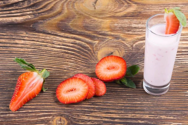 strawberry yoghurt with pulp on a wooden board