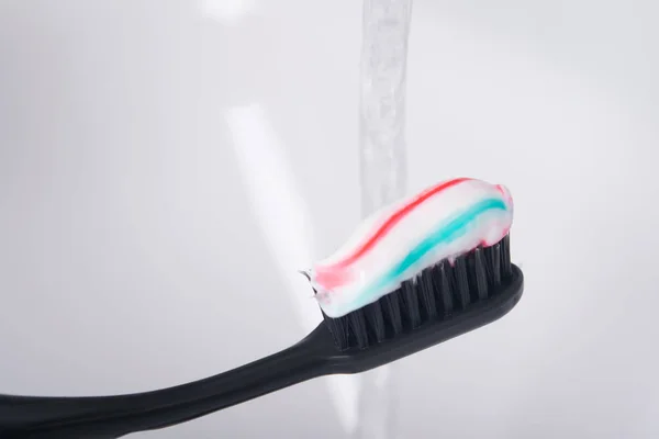Jet Water Multicolored Paste Black Toothbrush — Stock Photo, Image