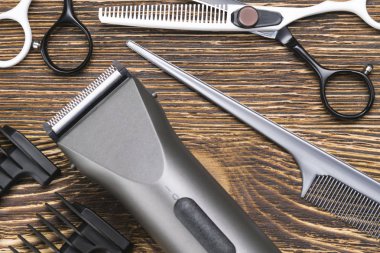 makas, saç fırçası, saç kesme makinesi yalan bir koyu ahşap tahta üzerine