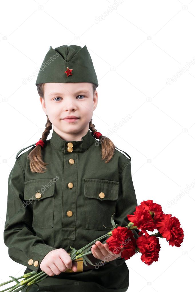 little girl in military uniform holds a bouquet of red flowers, isolated on white