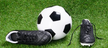 krampon ve top futbol, çim arka planı için