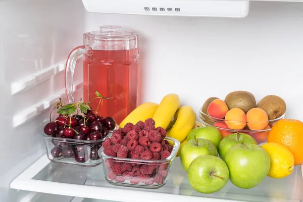 fruits, berries and fruit compote are stored on the top shelf of the refrigerator
